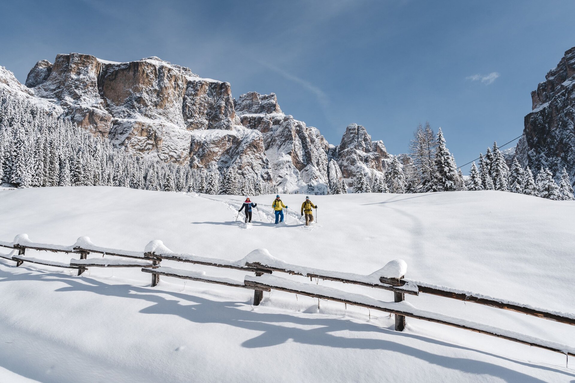 Gruppo di amici che ciaspola sotto al Sass Pordoi | © Patricia Ramirez - Archivio Immagini ApT Val di Fassa